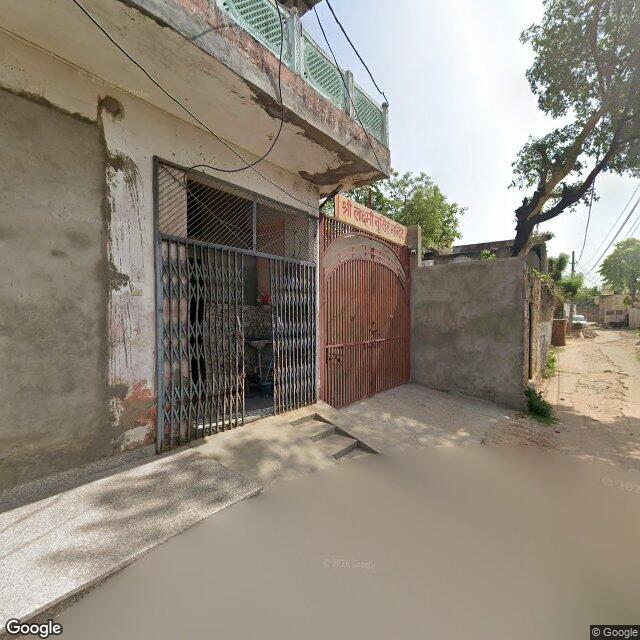 Along the street, away from the gate