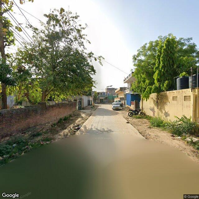 Along the street, away from the gate