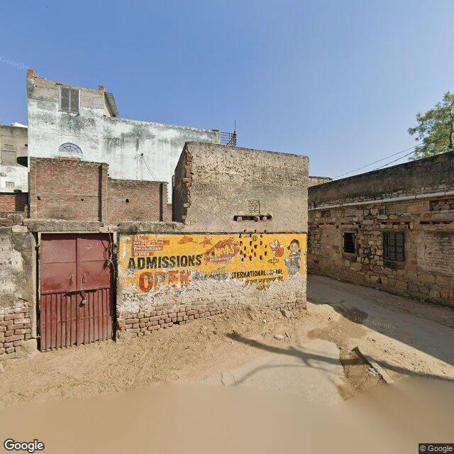 The frontage road, along the school wall