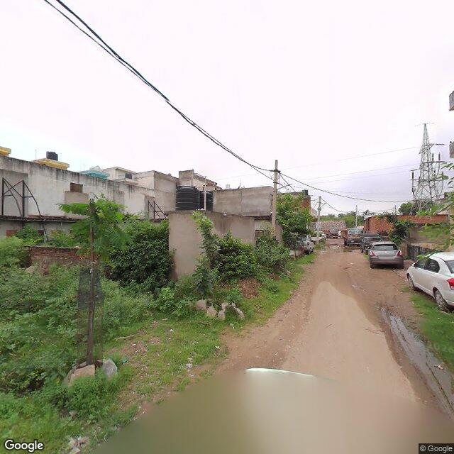 Along the street, away from the gate