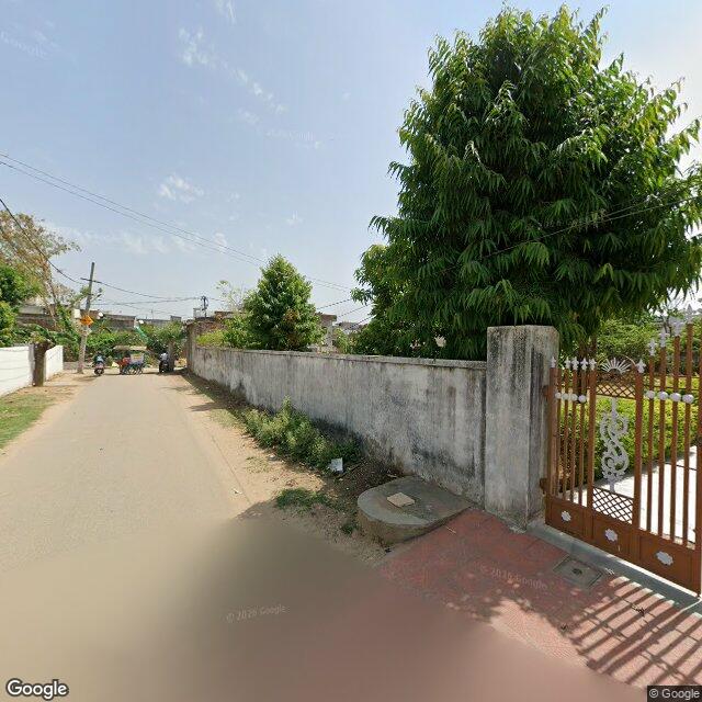 Along the street, away from the gate