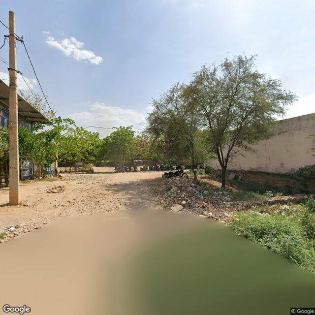 The frontage road, along the school wall
