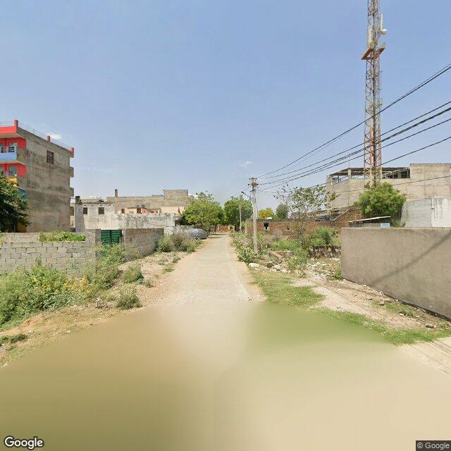 Along the street, away from the gate