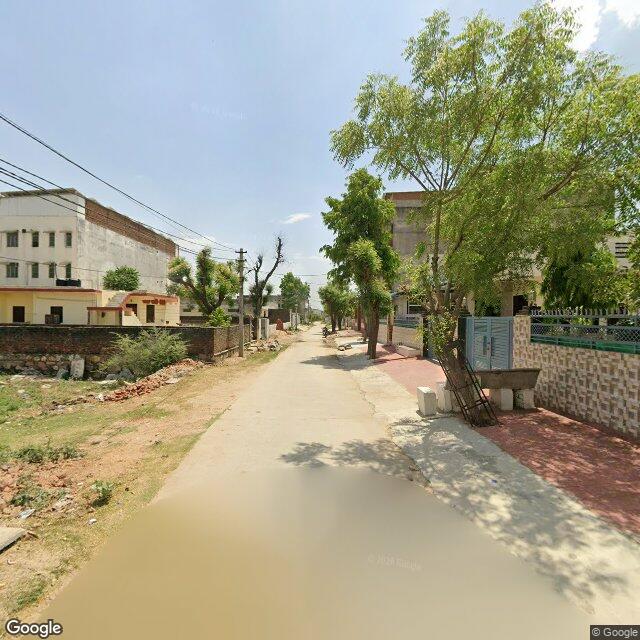 Along the street, away from the gate