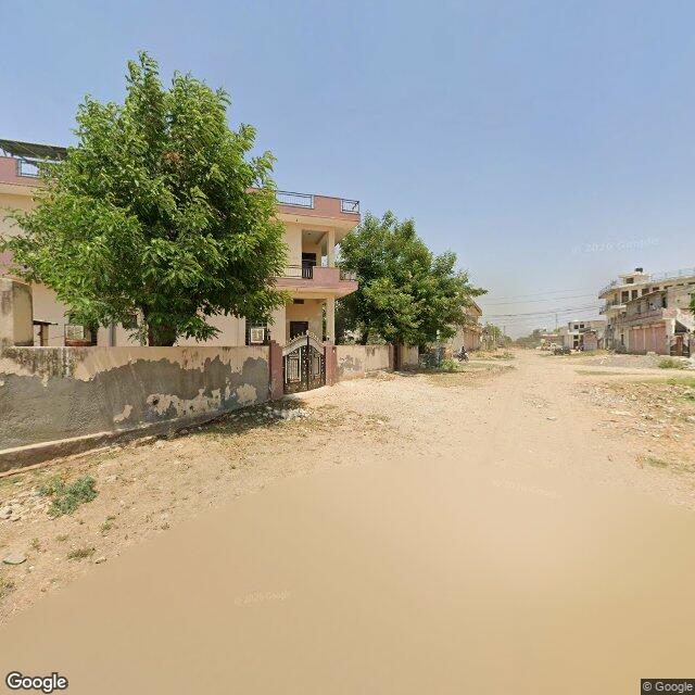 Along the street, away from the gate