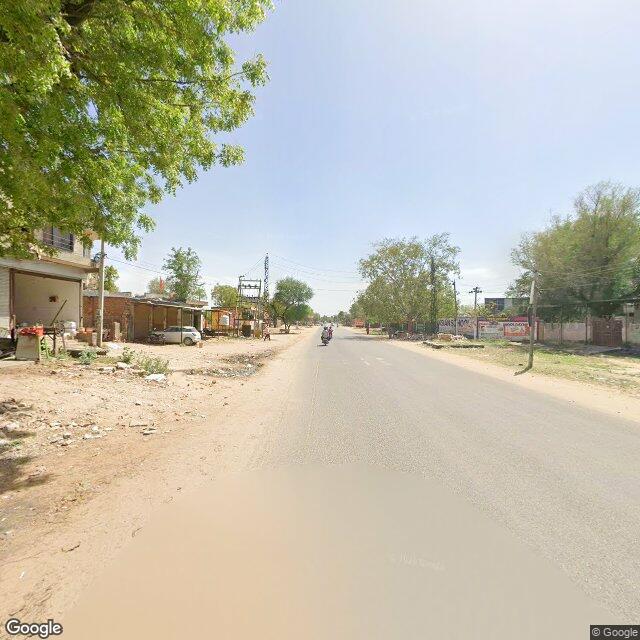 Along the street, away from the gate