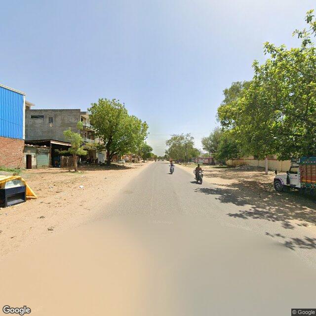 The frontage road, along the school wall