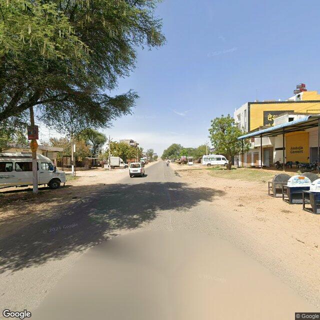 The frontage road, along the school wall