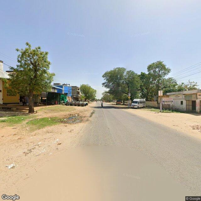 Along the street, away from the gate