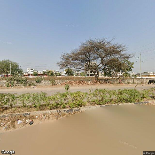 The frontage road, along the school wall