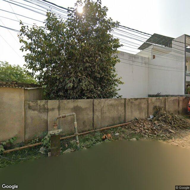Along the street, away from the gate