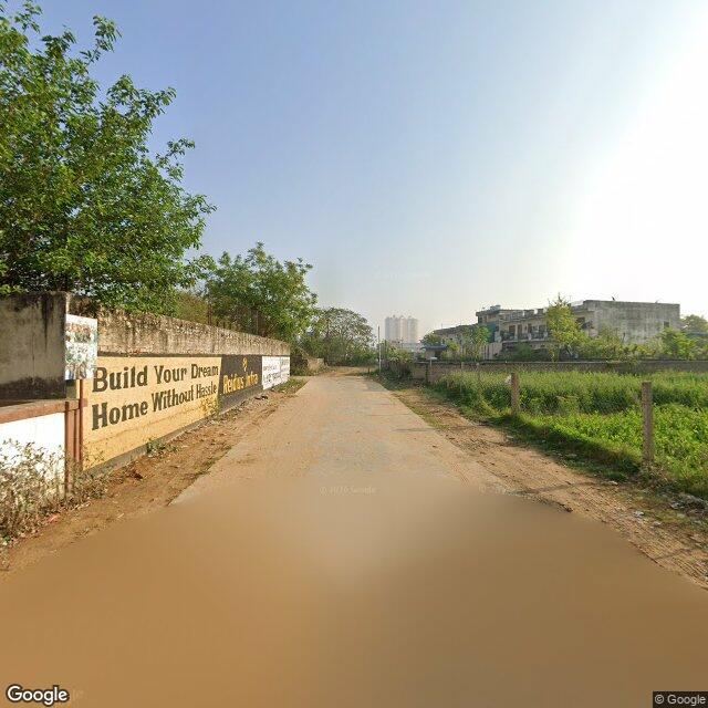 The frontage road, along the school wall