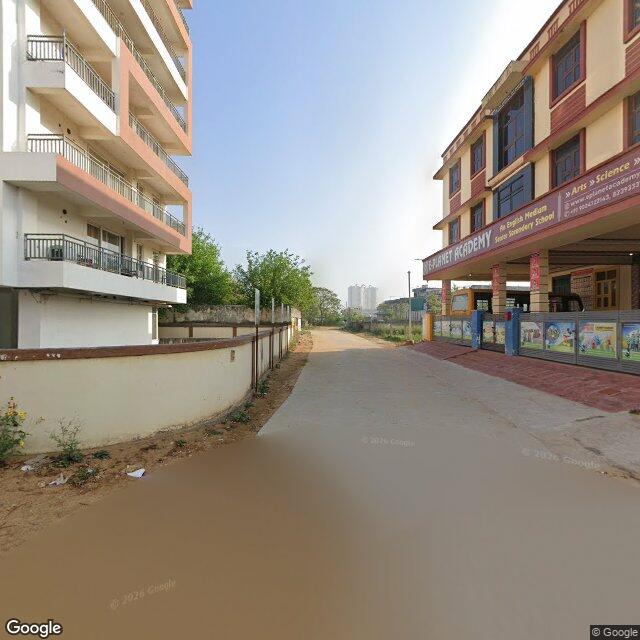 The frontage road, along the school wall