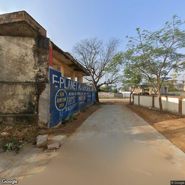 The frontage road, along the school wall