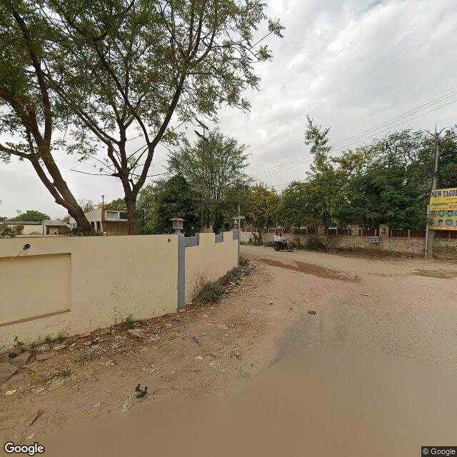 Along the street, away from the gate