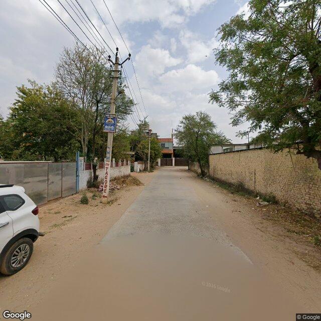 Along the street, away from the gate