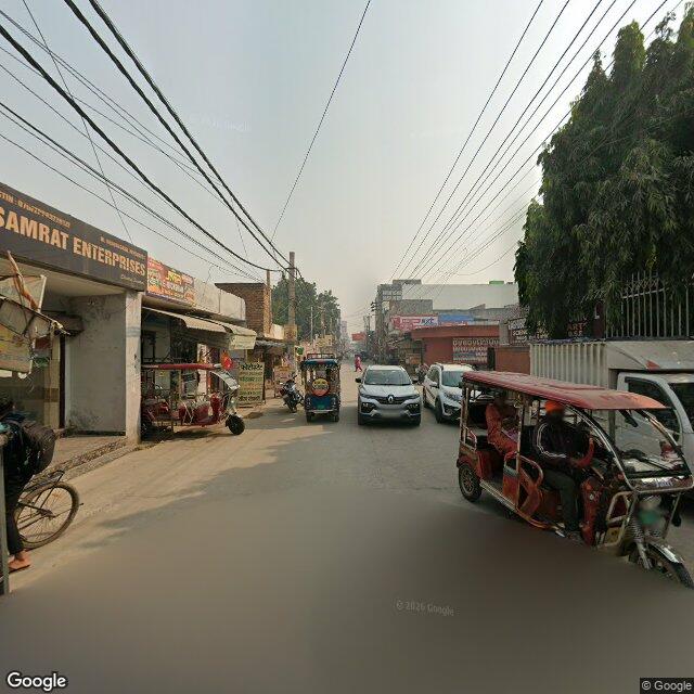 Along the street, away from the gate