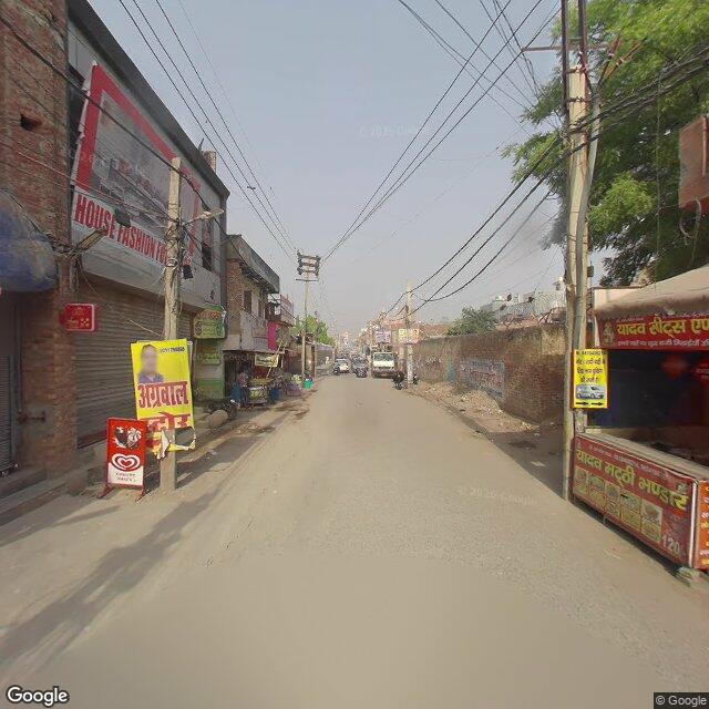 Along the street, away from the gate