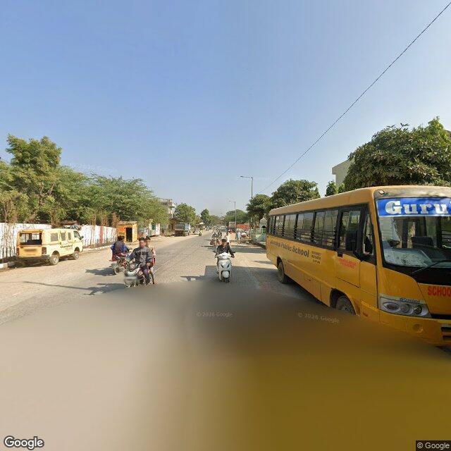 The frontage road, along the school wall