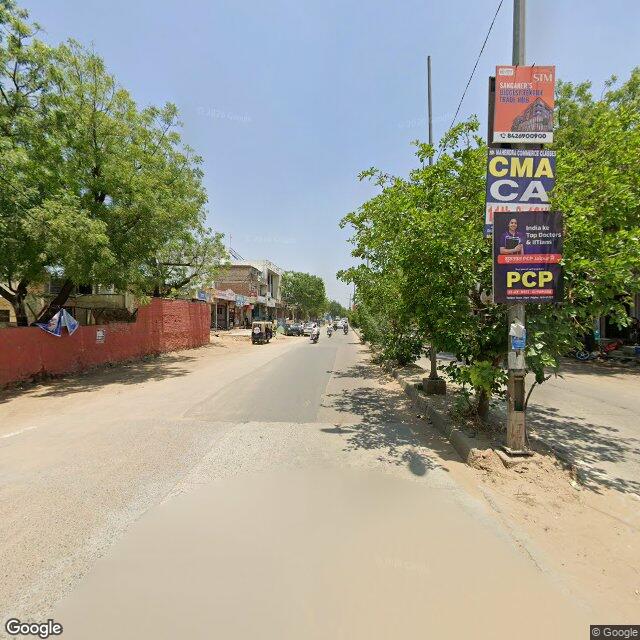 The frontage road, along the school wall