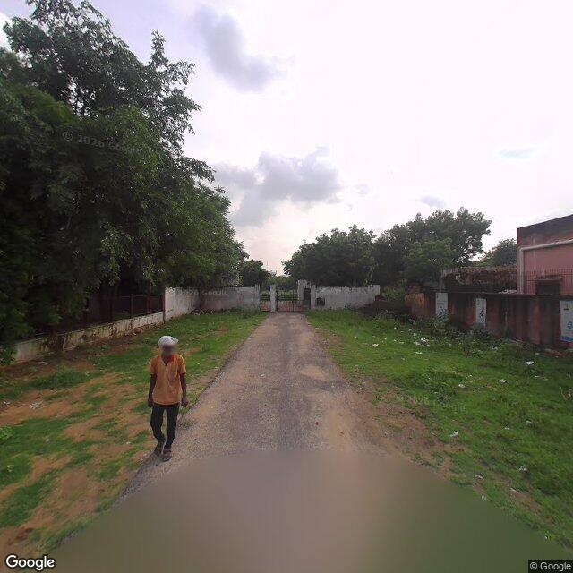 Along the street, away from the gate