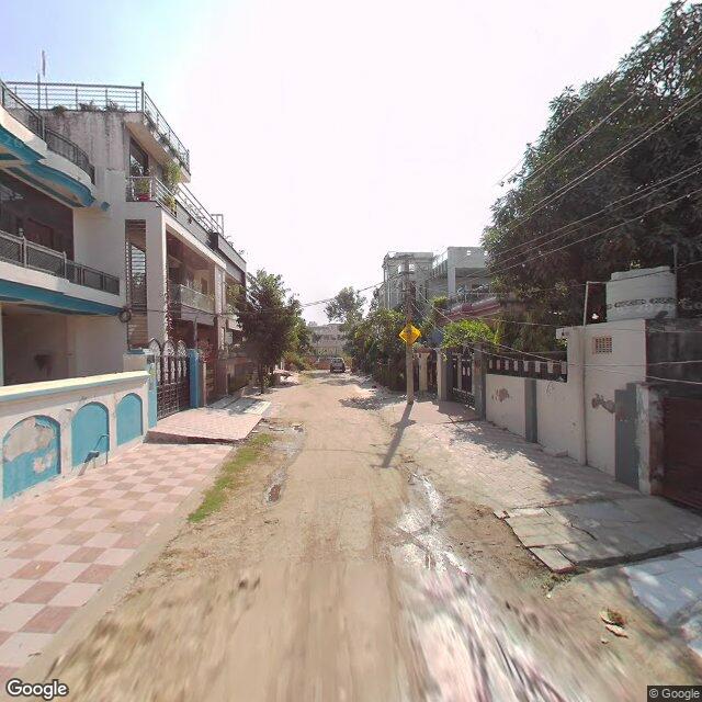 Along the street, away from the gate