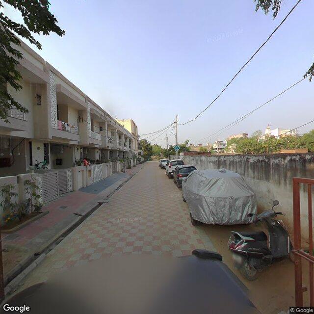 Along the street, away from the gate