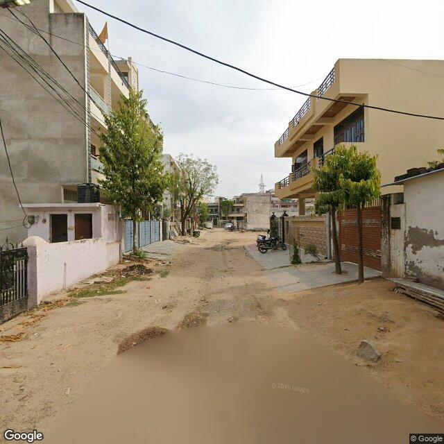 Along the street, away from the gate