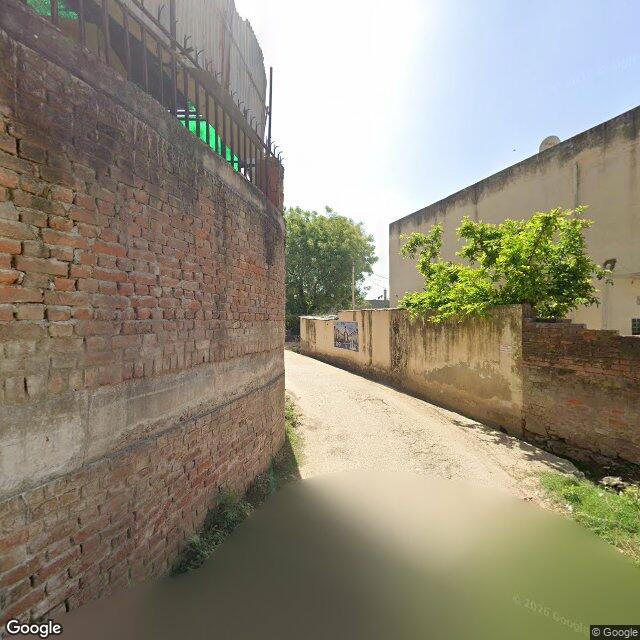 Along the street, away from the gate