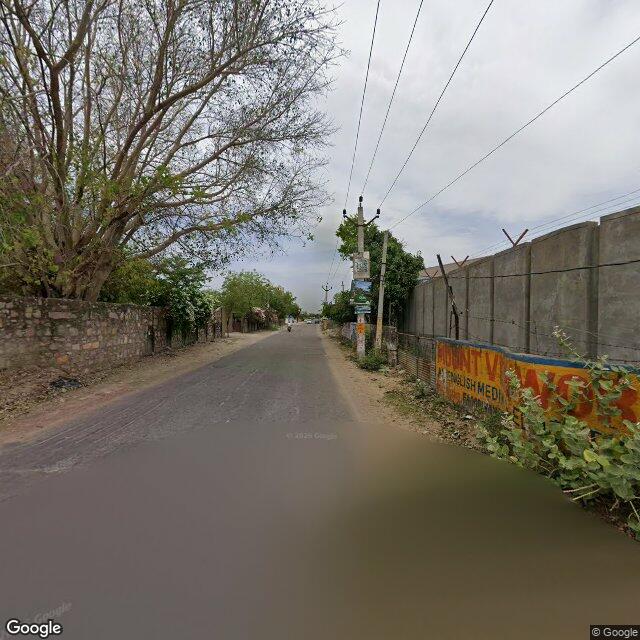 Along the street, away from the gate