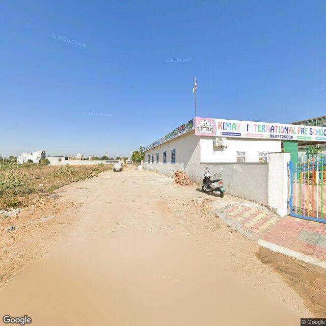 The frontage road, along the school wall