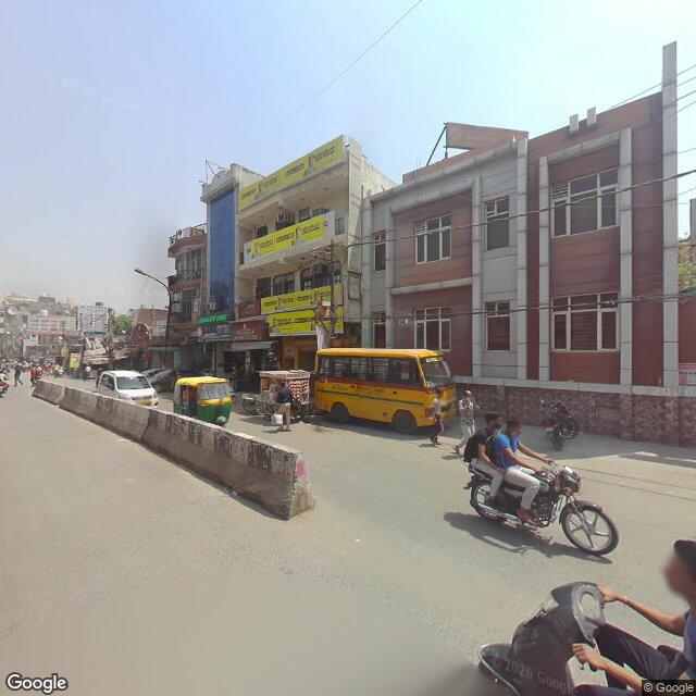 The frontage road, along the school wall