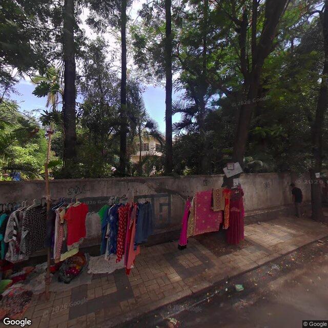 Along the street, away from the gate