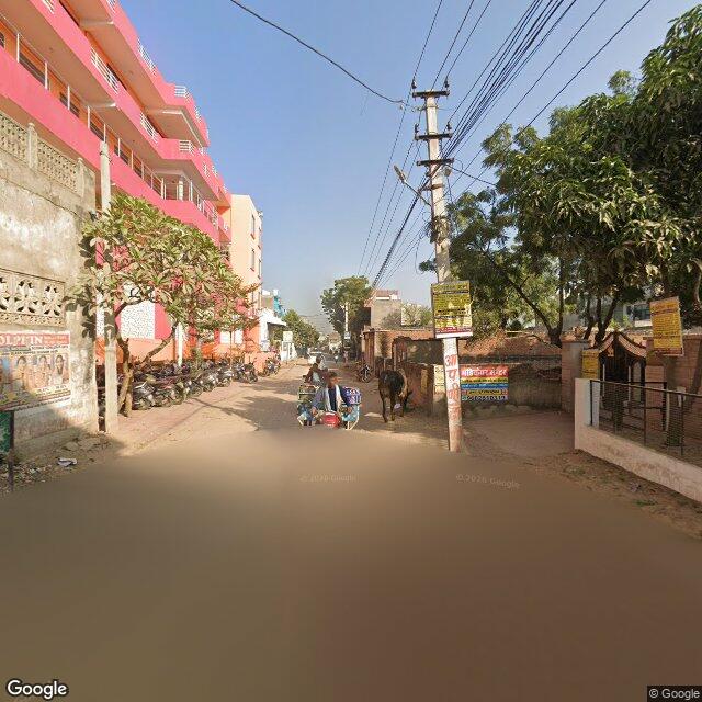 The frontage road, along the school wall