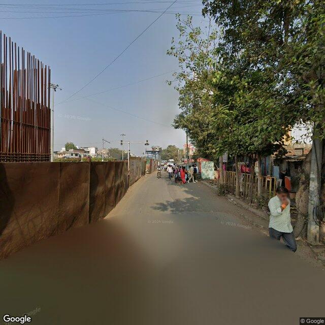 The frontage road, along the school wall