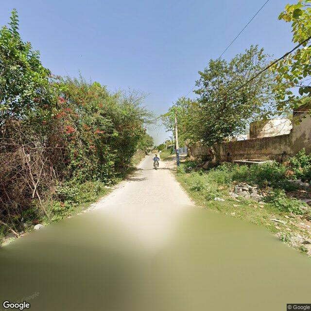 The frontage road, along the school wall