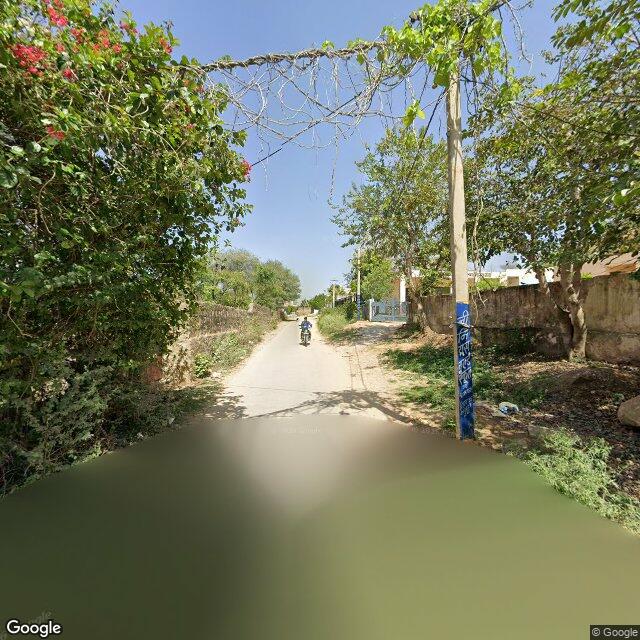 Along the street, away from the gate