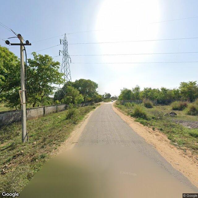 Along the street, away from the gate