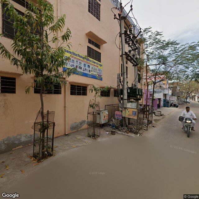 Along the street, away from the gate