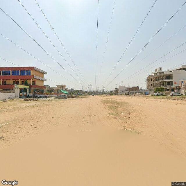 Along the street, away from the gate