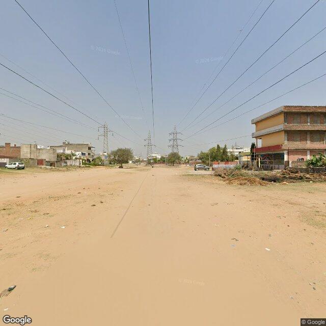 Along the street, away from the gate
