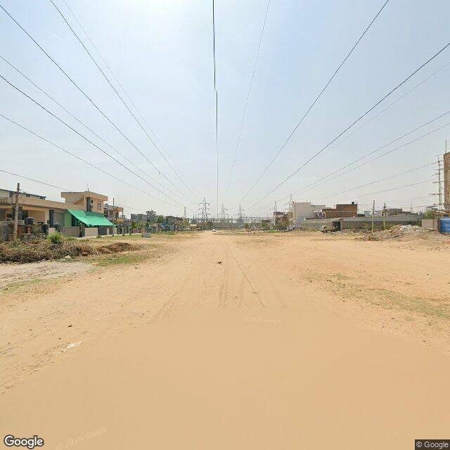 The frontage road, along the school wall