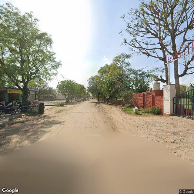 Along the street, away from the gate