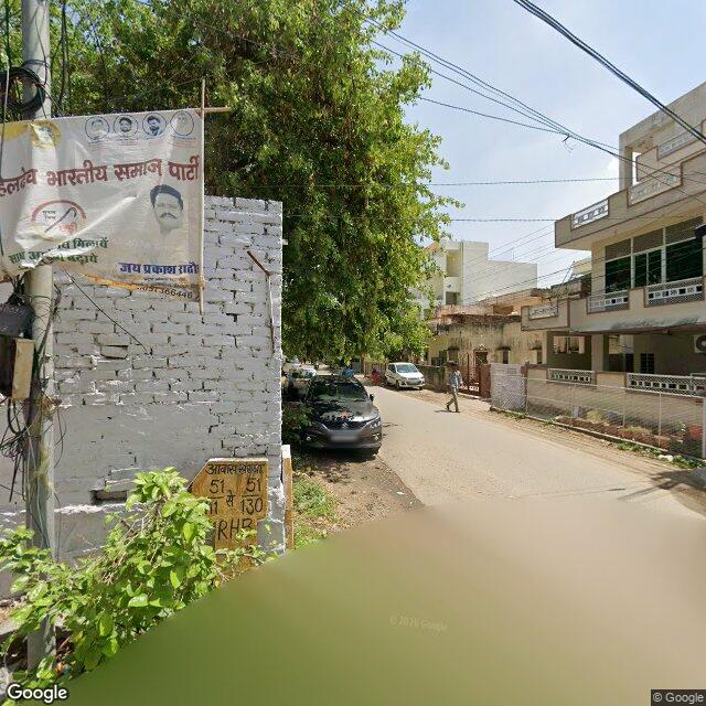 Along the street, away from the gate