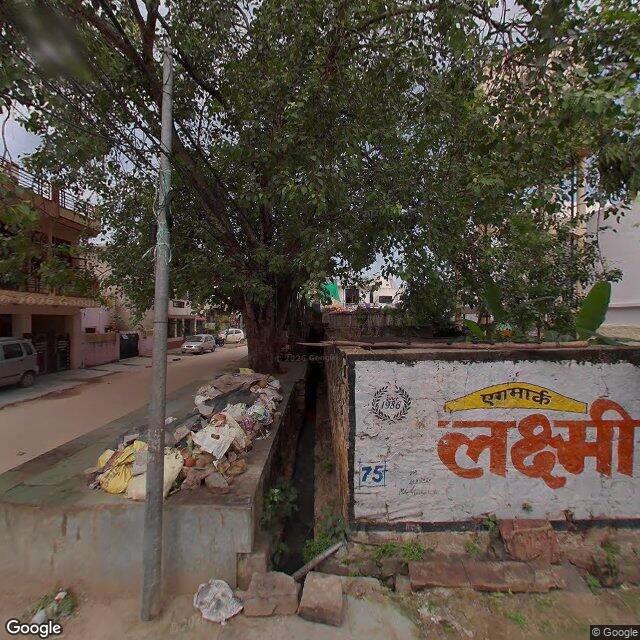 Along the street, away from the gate