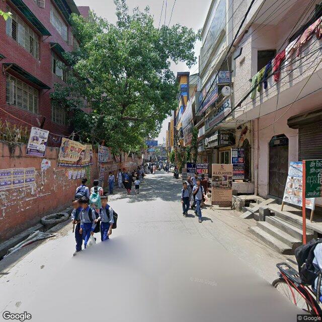 Along the street, away from the gate