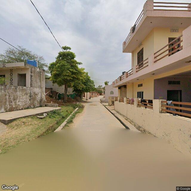 Along the street, away from the gate