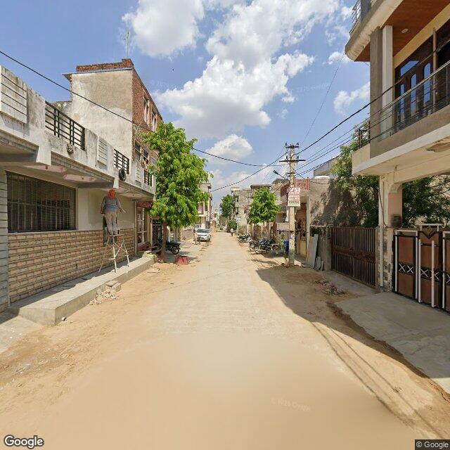 Along the street, away from the gate