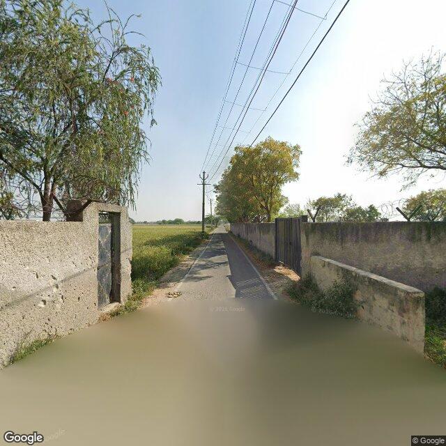 The frontage road, along the school wall