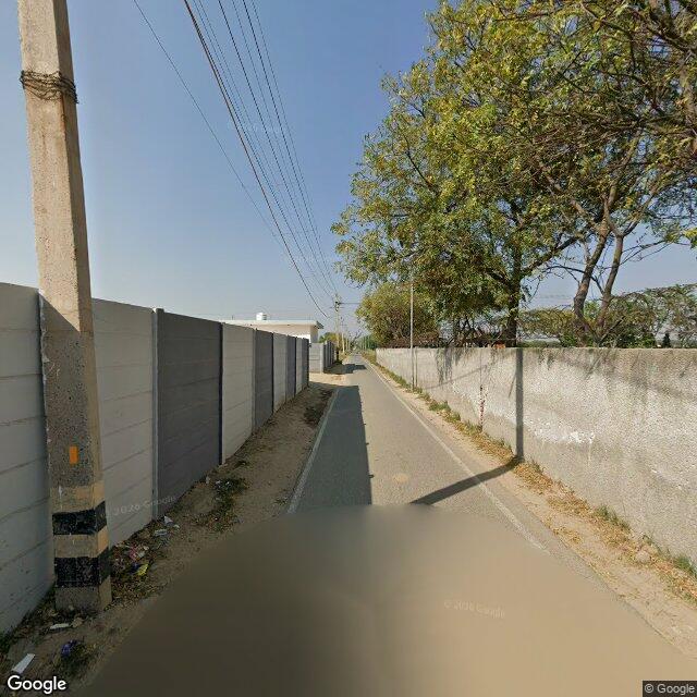 Along the street, away from the gate